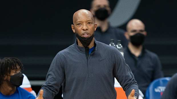 Sam Cassell stands on the sidelines.